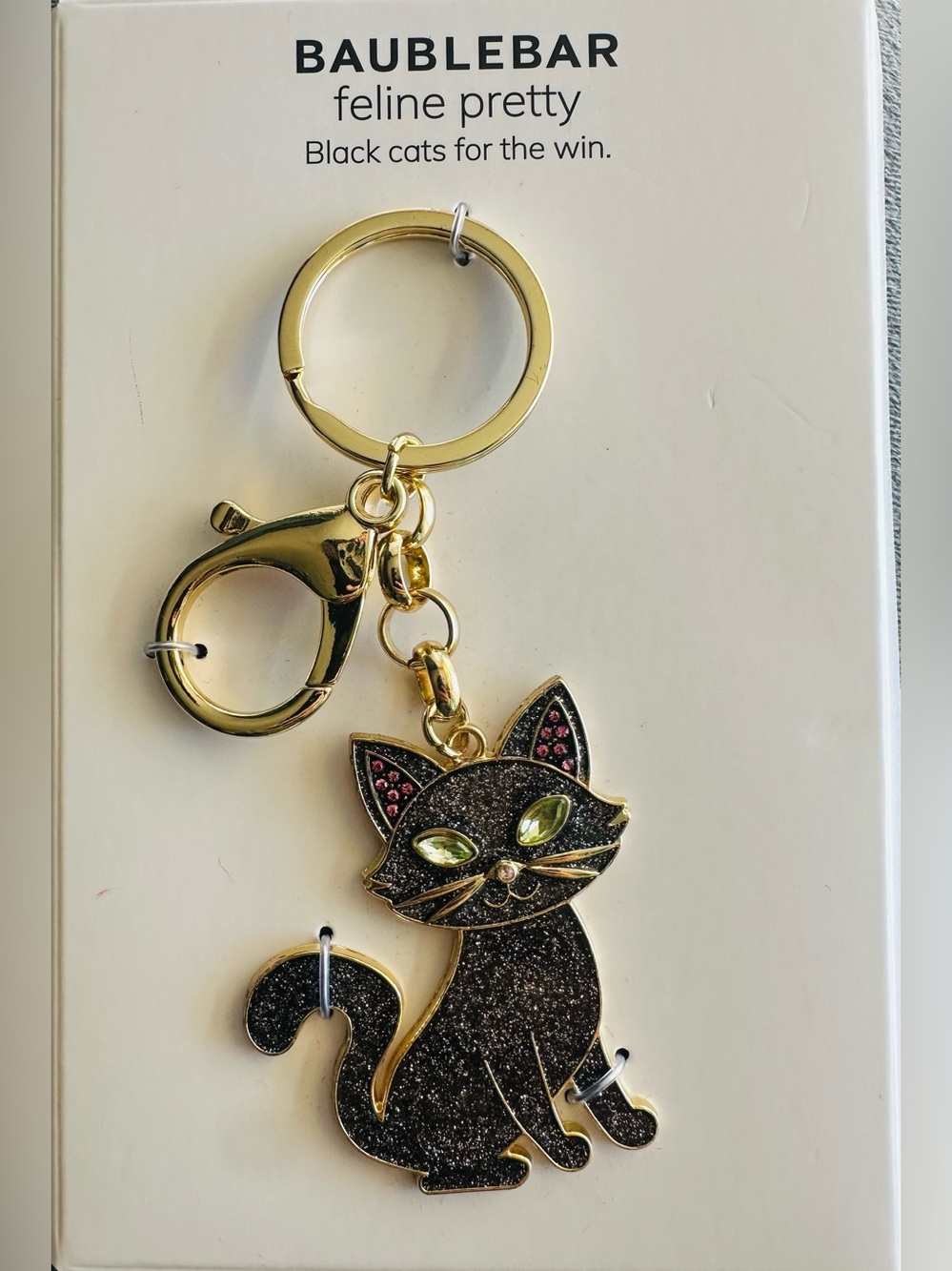 BaubleBar Black Cat Keychain with Gold Hardware and Green Eyes